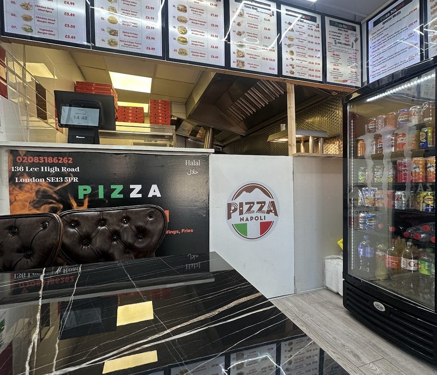 The shop interior: counter, drinks fridge and marble-tiled front